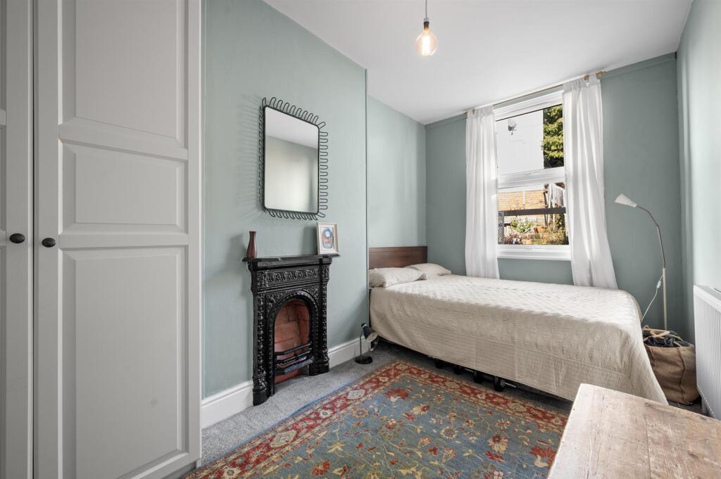 Bedroom One to fireplace and window.jpg