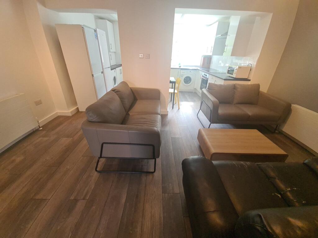 A cozy living room featuring comfortable sofas,...