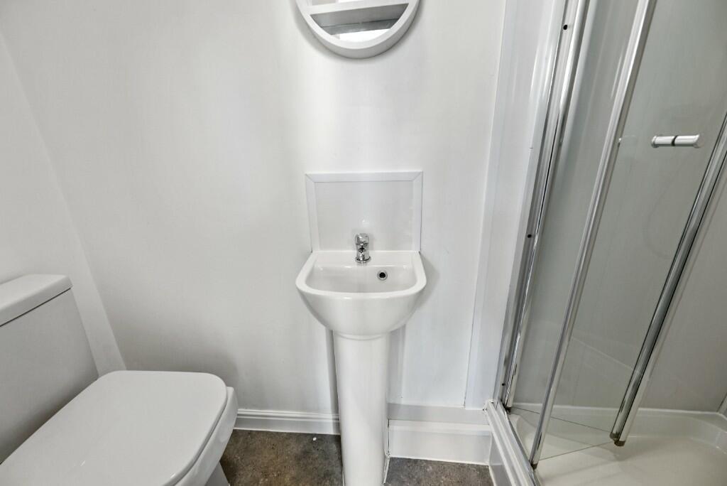 A clean and modern bathroom featuring a white t...