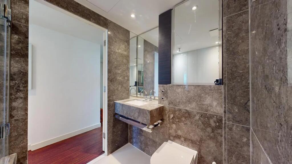 A modern bathroom suite featuring elegant stone...