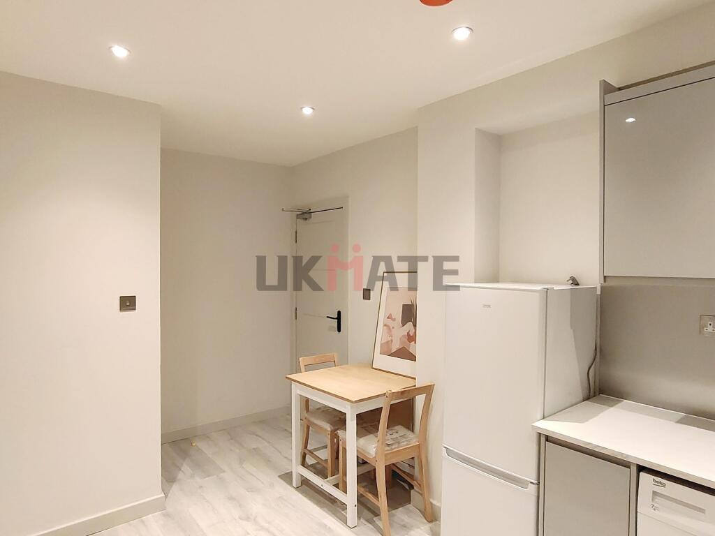 A bright, modern kitchen with ample lighting an...