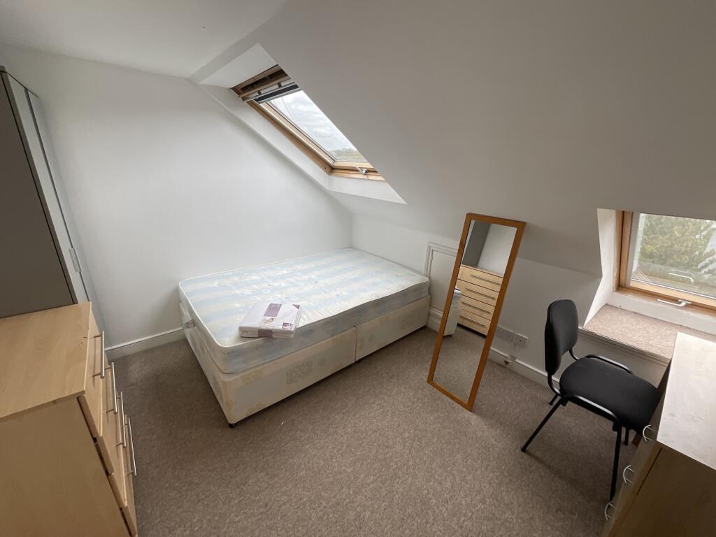 Bright and tidy small bedroom featuring a singl...