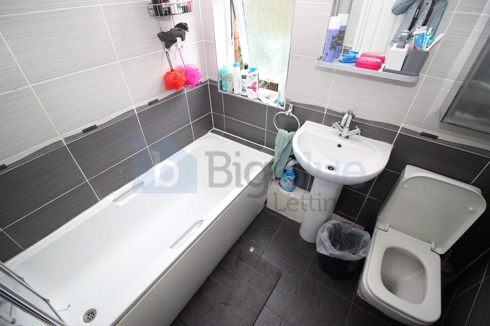 Bright and modern bathroom featuring a full-siz...