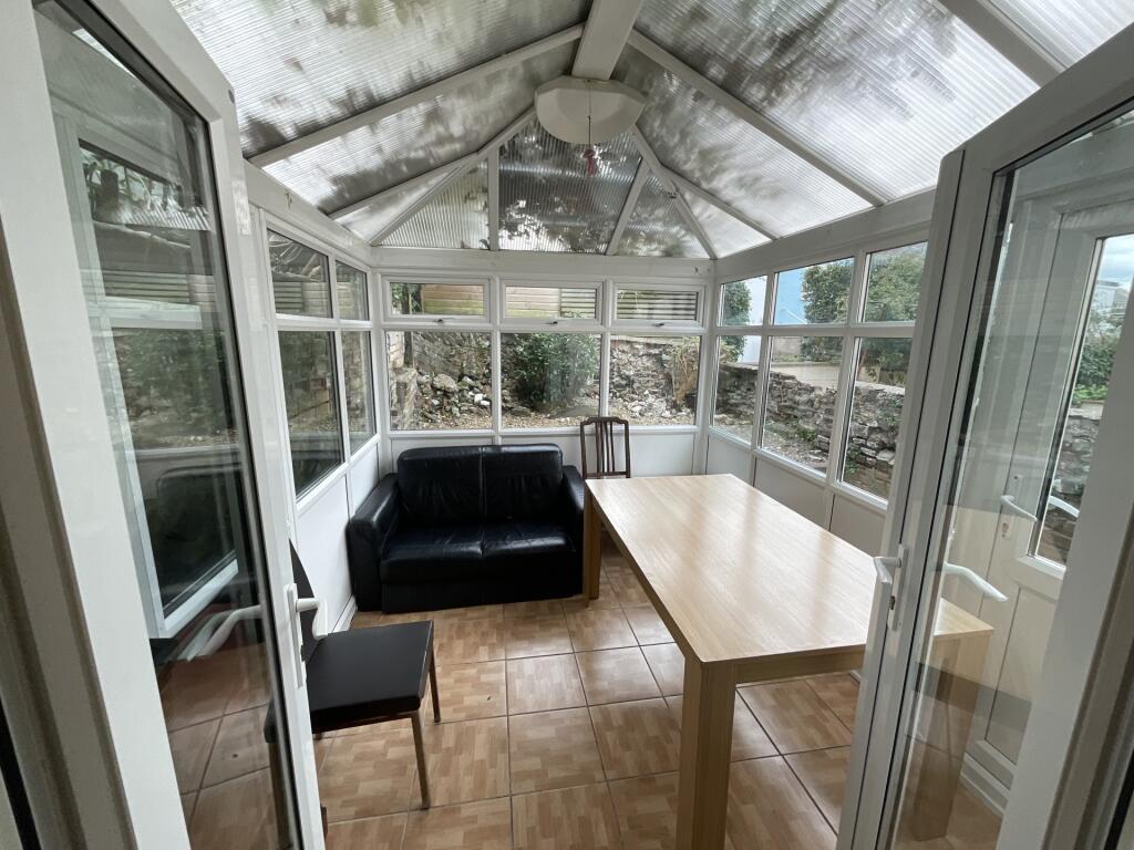 Bright and airy communal lounge with large wind...