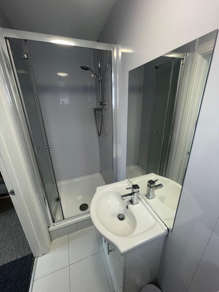 A neat and modern bathroom featuring a shower e...