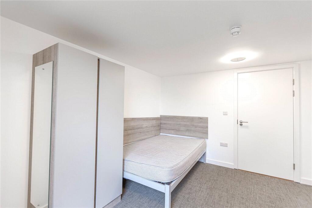 Bright and tidy single bedroom featuring a neat...