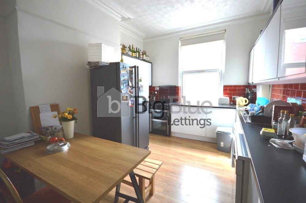 Bright and airy kitchen featuring modern applia...