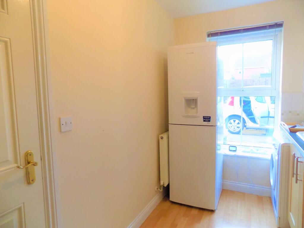 Bright kitchen area with a modern fridge freeze...