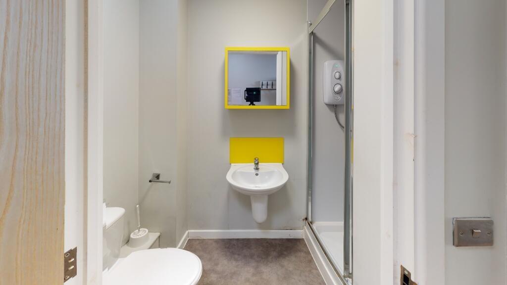 A modern bathroom featuring a clean white toile...
