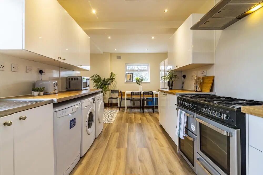 Bright and modern kitchen featuring ample count...