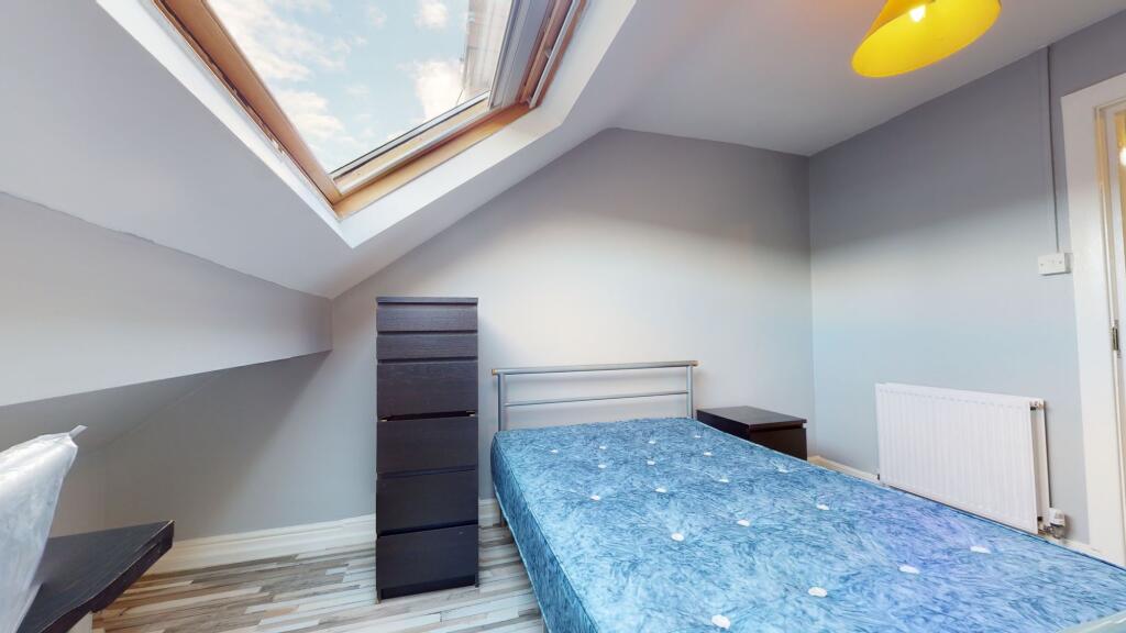 A bright and airy bedroom featuring a skylight ...
