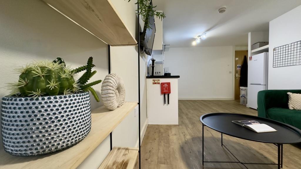 A modern living room featuring a neat wooden fl...