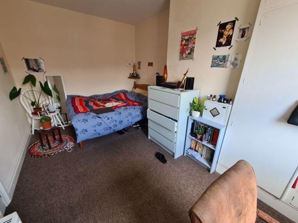 Cozy single bedroom featuring a comfortable bed...