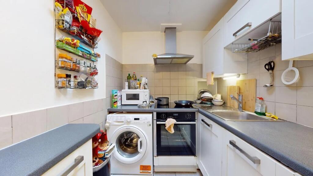 Bright and practical kitchen featuring modern w...