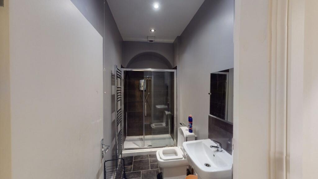 A modern bathroom featuring a large walk-in sho...