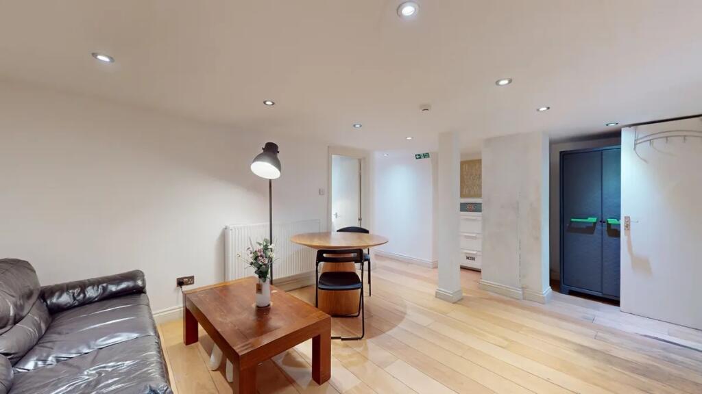 A modern living room featuring warm wooden floo...