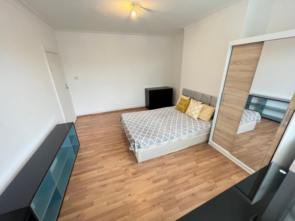 A tidy double bedroom featuring a comfortable b...