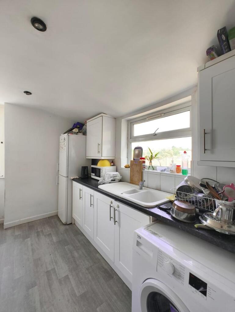 Bright and functional kitchen with ample counte...