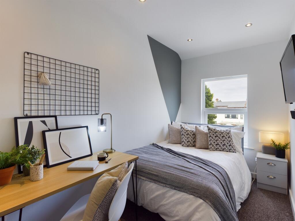 A bright and stylish double bedroom featuring m...