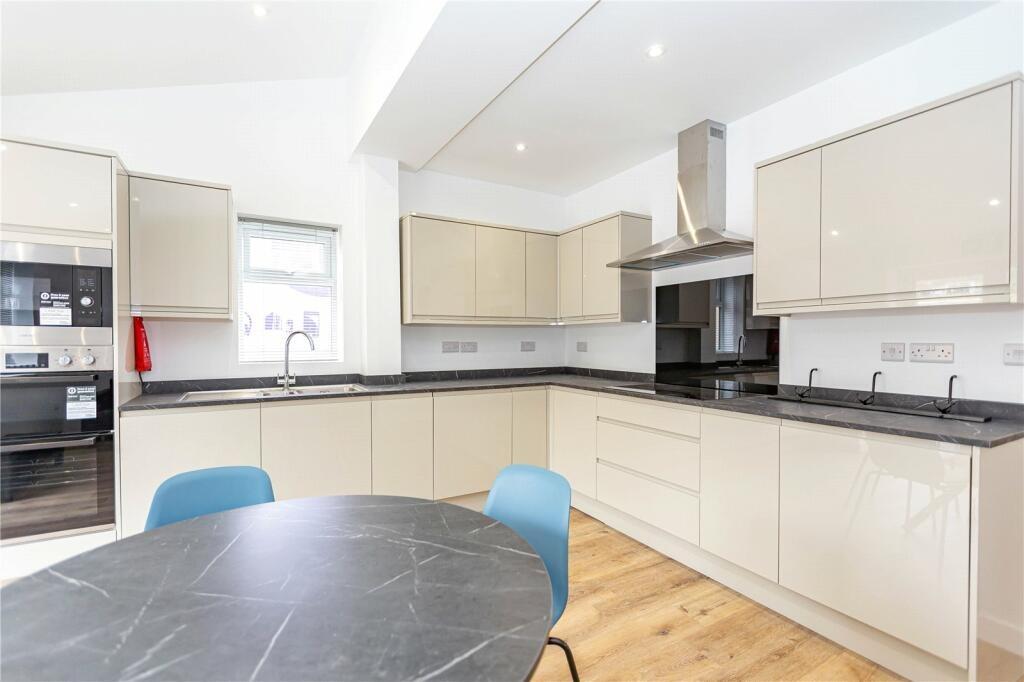Bright and modern kitchen featuring sleek cream...