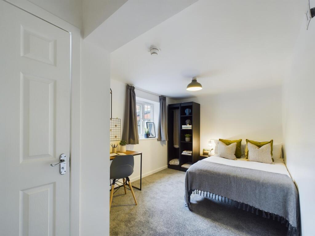 A bright and inviting double bedroom featuring ...