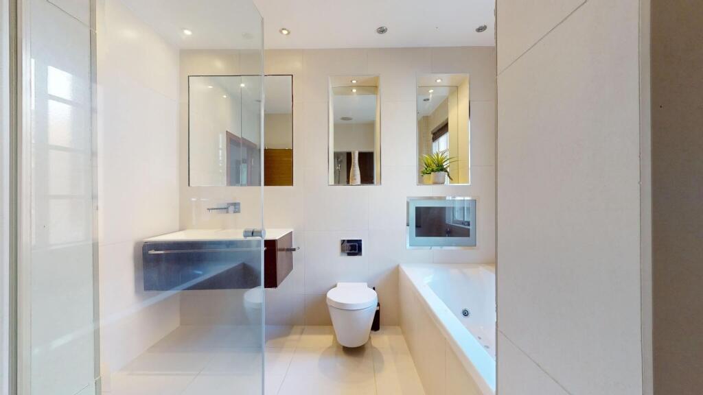 A sleek and modern bathroom suite featuring a l...