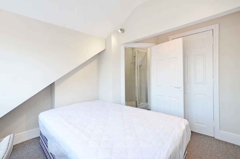 A bright and clean double bedroom featuring a l...