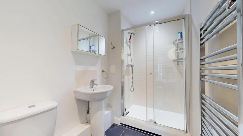 Bright and clean modern bathroom featuring a sp...