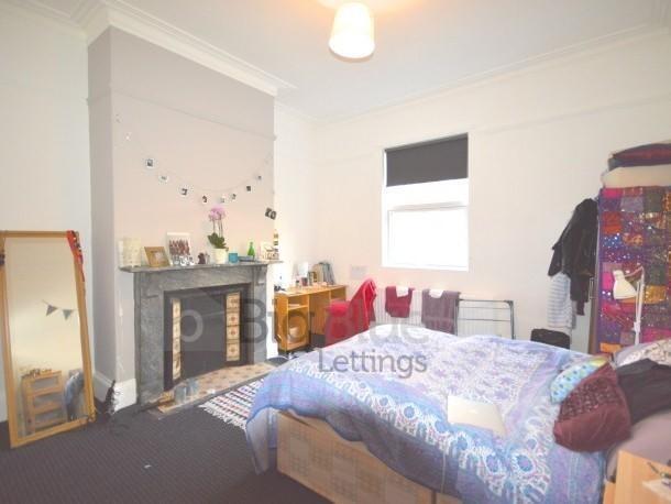 Bright and spacious master bedroom featuring a ...