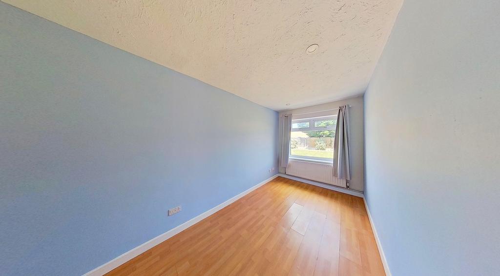A room with a wooden floor and blue walls.