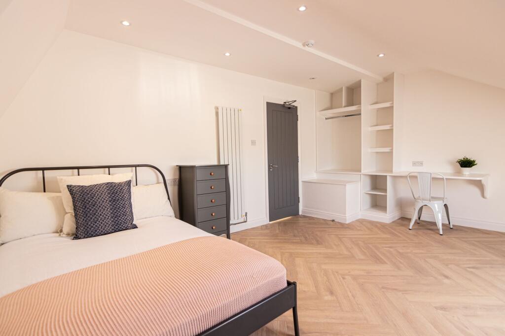 Bright and welcoming master bedroom featuring a...