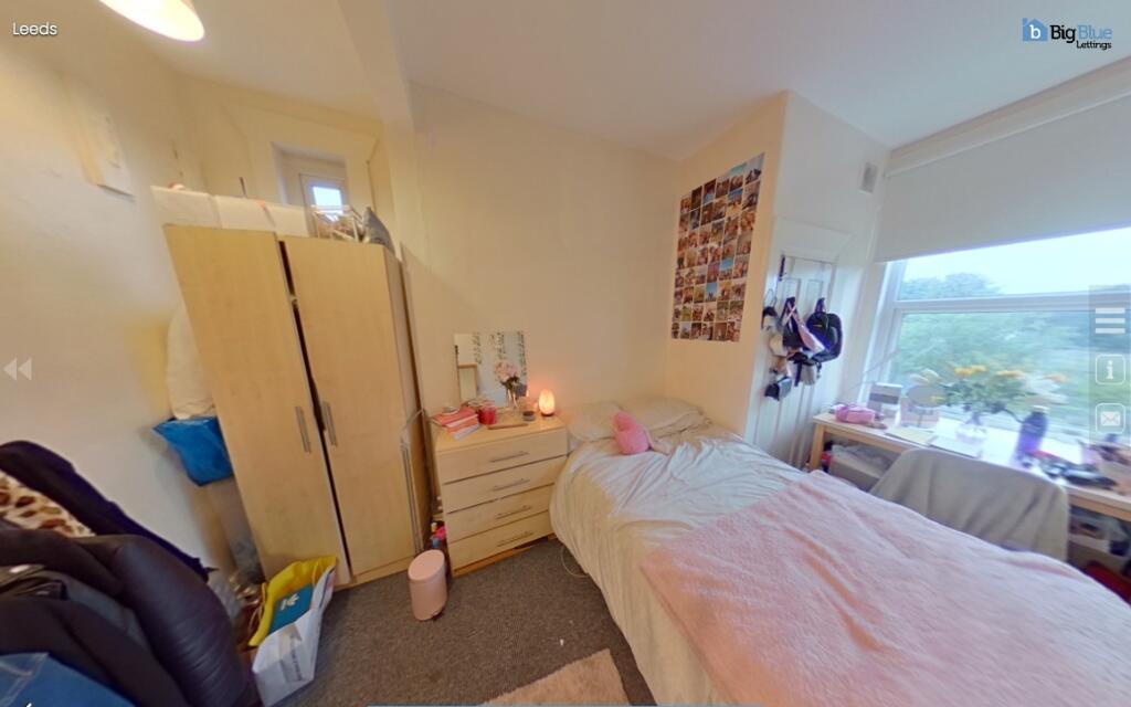 Cozy bedroom with a large window providing ampl...