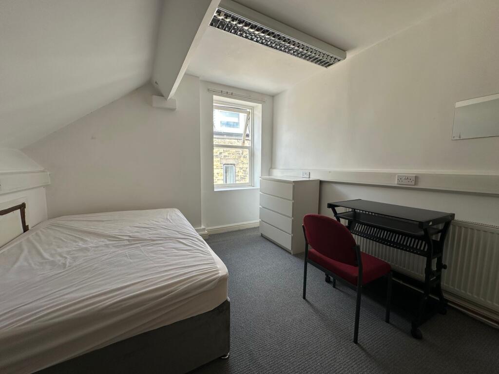 A neat and simple single bedroom featuring a be...