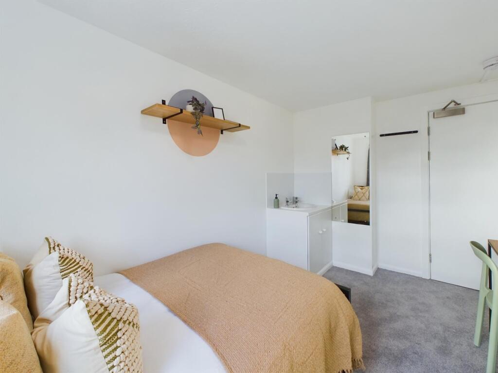 A bright and inviting double bedroom featuring ...