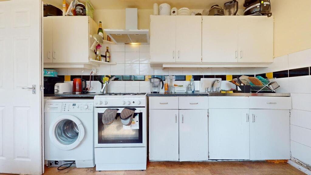 A compact kitchen featuring essential appliance...