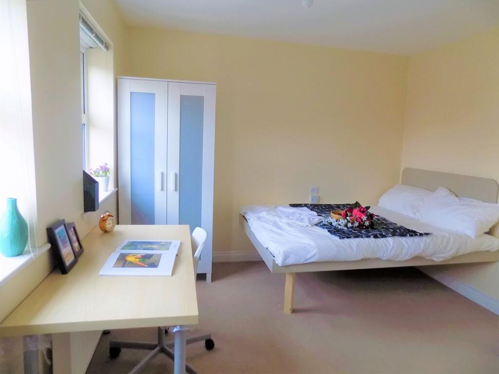 A bright and tidy double bedroom featuring a co...