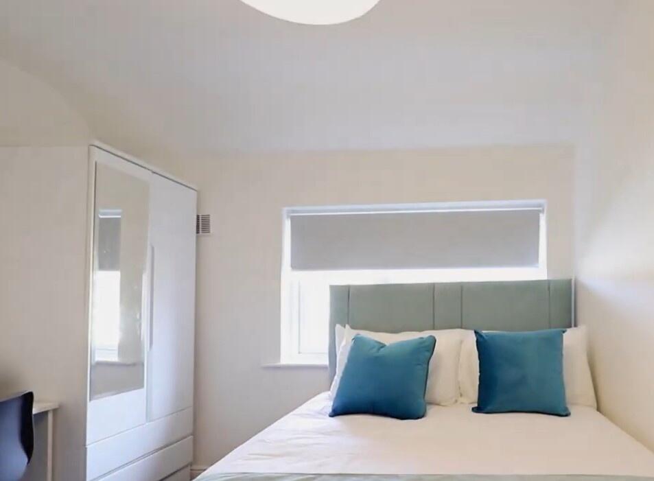 Bright and cozy double bedroom featuring a comf...