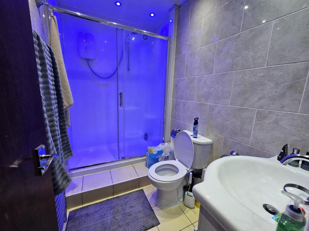 A modern bathroom featuring a large shower with...