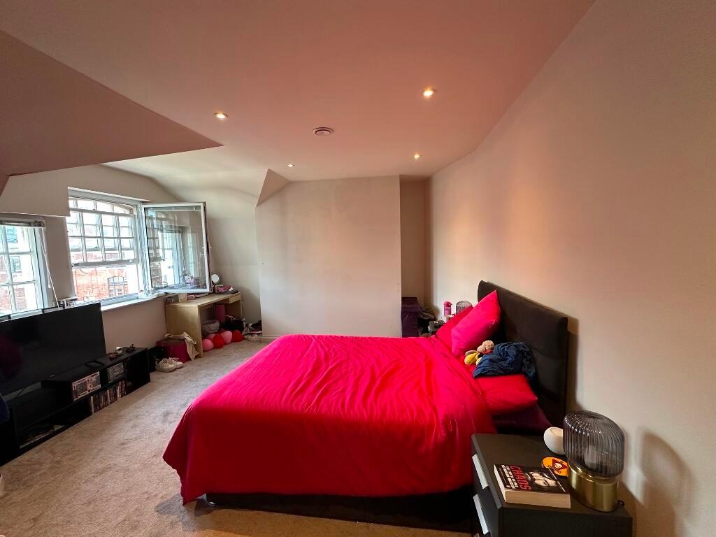 A spacious master bedroom featuring a large dou...