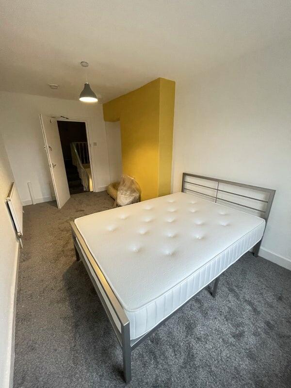 A tidy double bedroom featuring a fresh mattres...