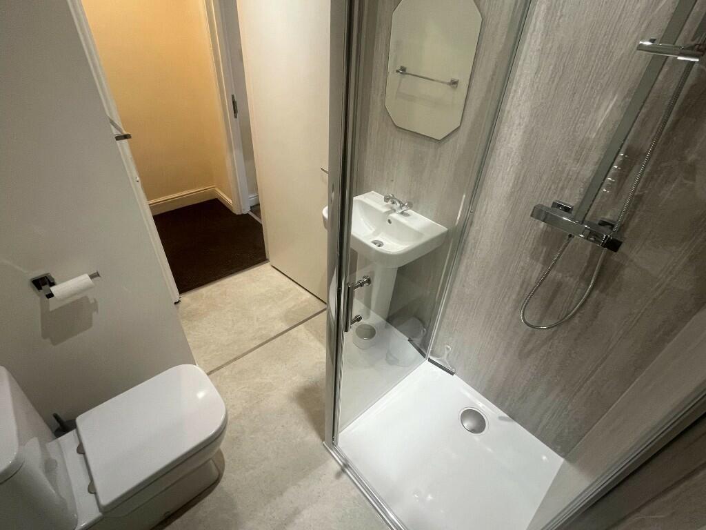 Bright and modern bathroom featuring a walk-in ...