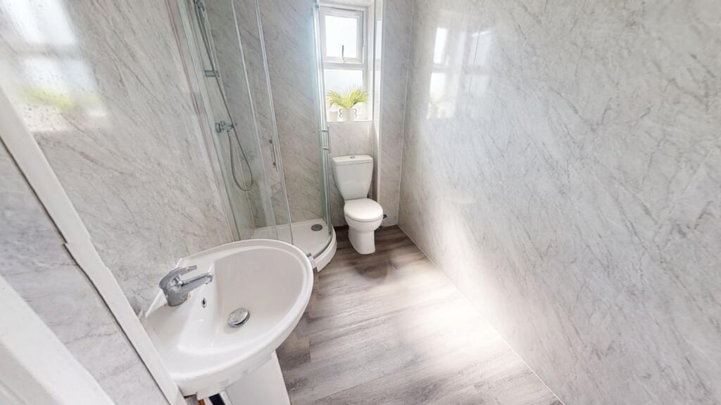 Bright and clean bathroom with modern grey tile...