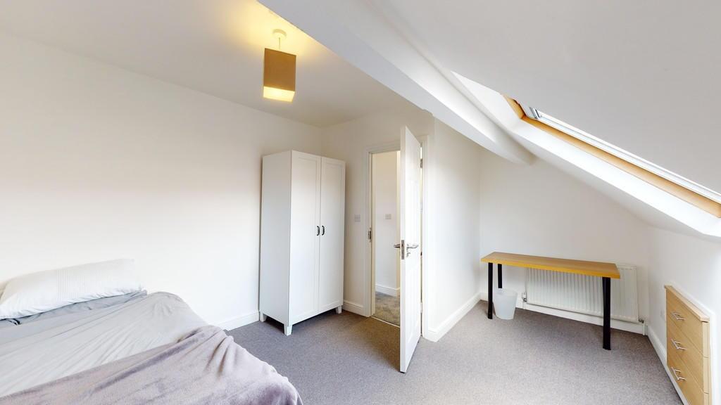 A spacious and bright master bedroom featuring ...