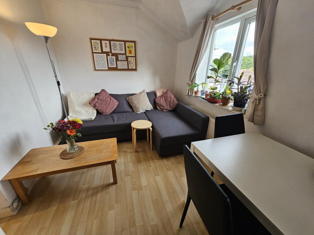 Bright and welcoming living room featuring a la...