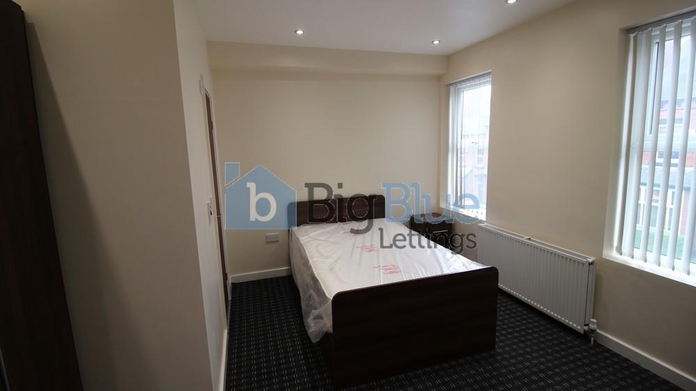 A bright and clean master bedroom featuring a c...