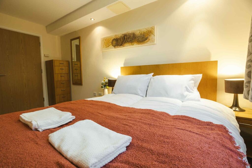 A warm and inviting master bedroom featuring a ...