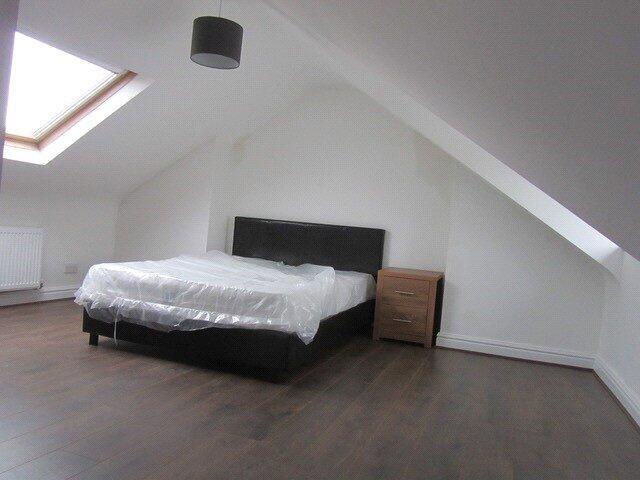A spacious master bedroom featuring a large dou...