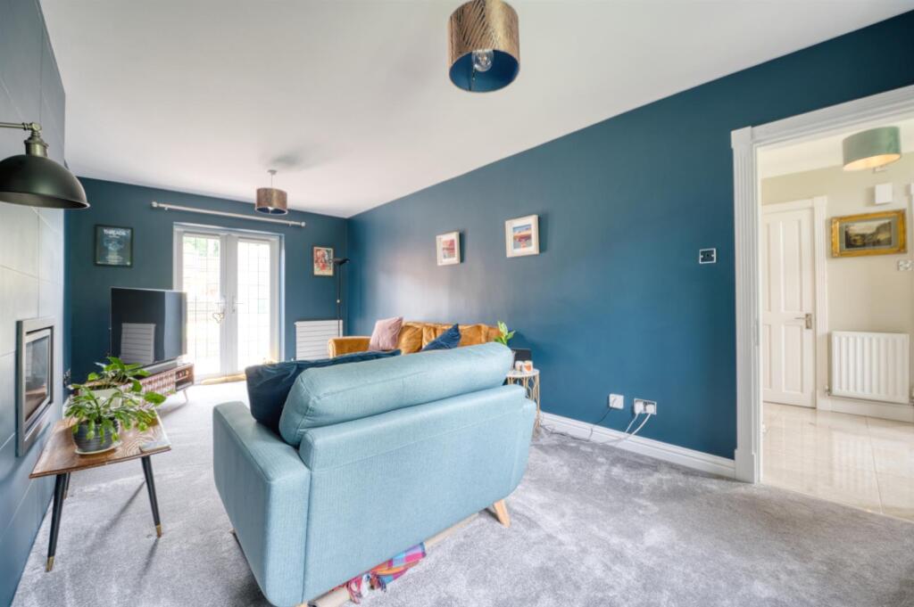 Sitting Room towards garden and hallway.jpg