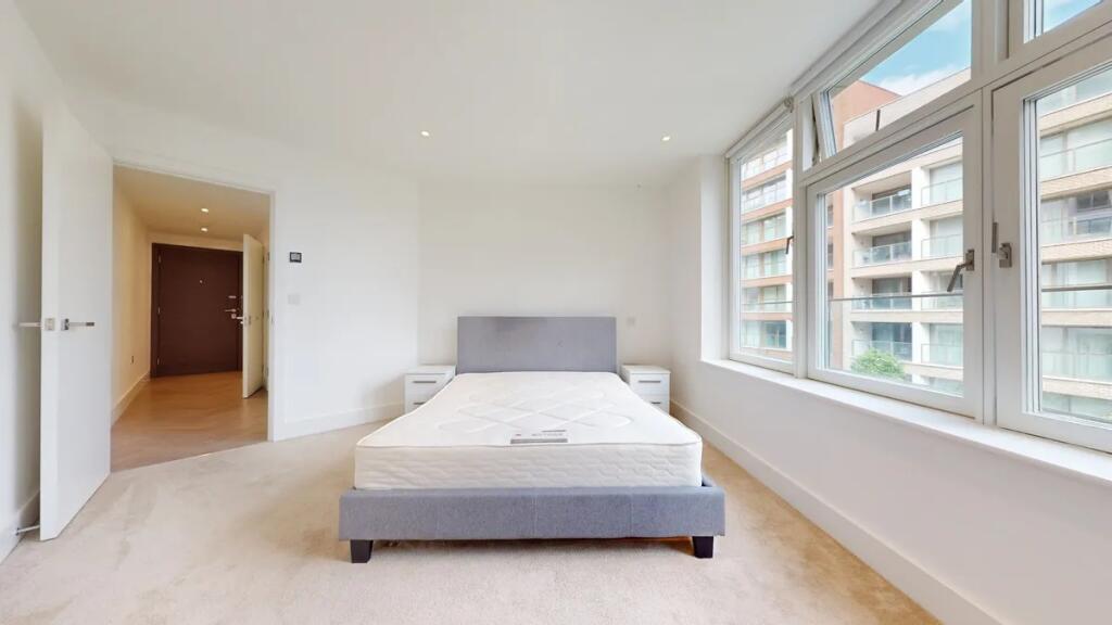 A bright and airy double bedroom featuring a mo...