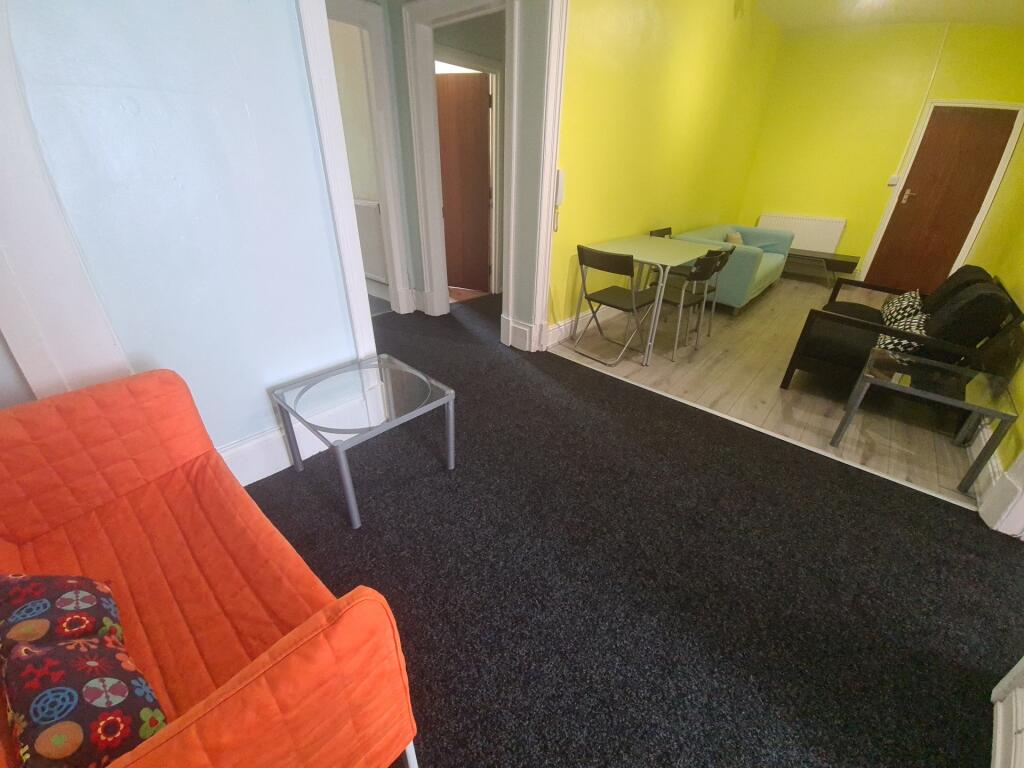 A spacious and welcoming living room featuring ...